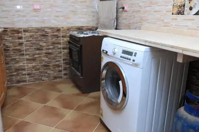 a washing machine in a room with a counter at Ahmed Mulatam House in Luxor