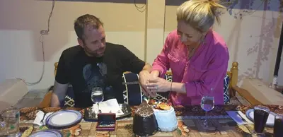 a man and a woman cutting a cake on a table at Luxor Villa Hatshepsut in Luxor