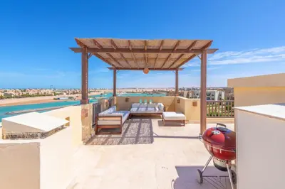 a patio with a gazebo on a roof at Sunny 2 Bedroom + Private Roof Terrace Lagoon View in Hurghada