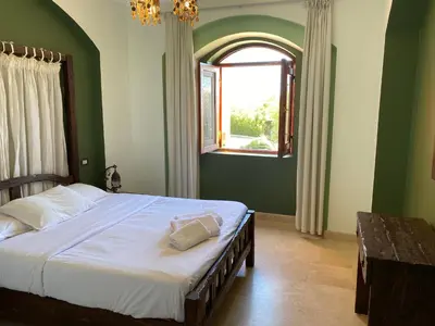 a bedroom with a large bed and a window at Lovely two bedroom apartment in Hurghada