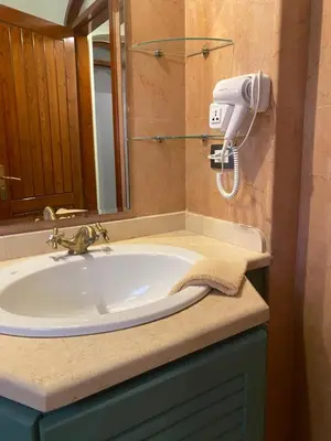 a bathroom sink with a hair dryer on a counter at Lovely two bedroom apartment in Hurghada