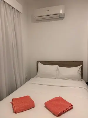 a white bed with two red towels on it at Aqua Palms Resort by Ivan C408 in Hurghada