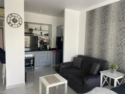 a living room with a couch and a table at Apartman Veranda in Hurghada