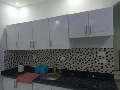 a kitchen with white cabinets and a sink at sheraton blaza329 in Hurghada