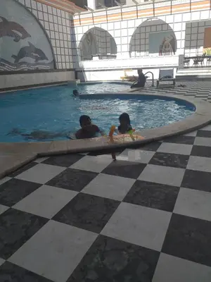 a man and a child in a swimming pool at sheraton blaza329 in Hurghada