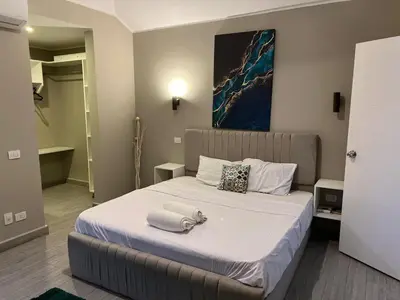 a bedroom with a bed with towels on it at 2BR Twin House With Private Heated Pool at El-Gouna -Seperate 1Bedroom & Seperate Guest studio- in Hurghada