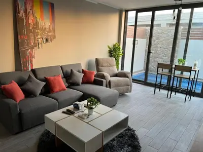 a living room with a couch and a coffee table at 2BR Twin House With Private Heated Pool at El-Gouna -Seperate 1Bedroom & Seperate Guest studio- in Hurghada