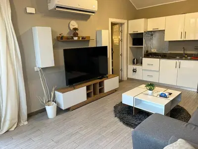 a living room with a flat screen tv and a couch at 2BR Twin House With Private Heated Pool at El-Gouna -Seperate 1Bedroom & Seperate Guest studio- in Hurghada
