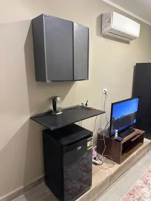 a room with a desk with a computer and a television at 2BR Twin House With Private Heated Pool at El-Gouna -Seperate 1Bedroom & Seperate Guest studio- in Hurghada