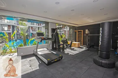 an indoor gym with a treadmill and a simulator at Luxury 95m Penthouse - Boutique Resort & Wifi in Hurghada