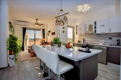 a kitchen and living room with a large kitchen island at Luxury 95m Penthouse - Boutique Resort & Wifi in Hurghada