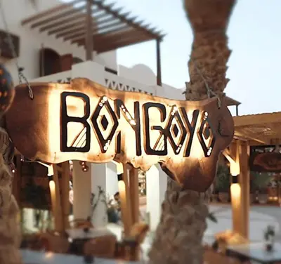 a sign that reads weapons hanging from a building at EL Gouna Swan Lake Apartment in Hurghada