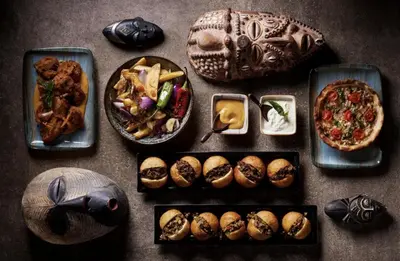 a table topped with plates of food and bowls of food at EL Gouna Swan Lake Apartment in Hurghada