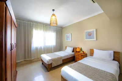 a hotel room with two beds and a window at AJIRA Bay Hotel Hurghada Marina in Hurghada