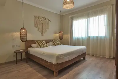 a bedroom with a large bed and a window at AJIRA Bay Hotel Hurghada Marina in Hurghada