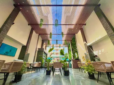 a room with chairs and potted plants on the ceiling at Imperial Resort Hurghada in Hurghada