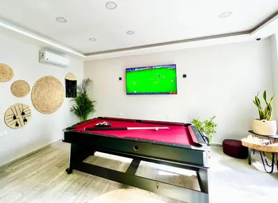a living room with a pool table and a flat screen tv at Imperial Resort Hurghada in Hurghada