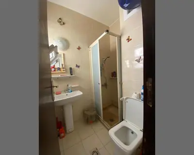 a bathroom with a shower and a sink and a toilet at Чудесная студия в комплексе с бассейном рядом с бесплатным пляжем in Hurghada