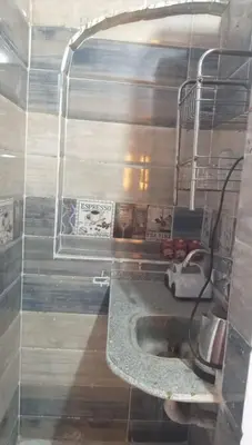 a bathroom with a sink and a shelf at Aziza House in Aswan