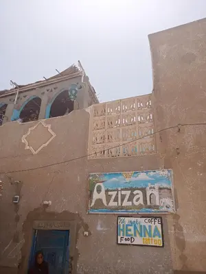 a building with a sign on the side of it at Aziza House in Aswan