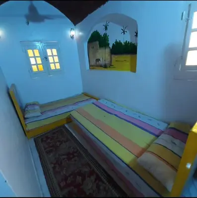 a bedroom with a large bed in a room at Aziza House in Aswan