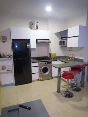 a kitchen with a black refrigerator and a washing machine at Central location Aqua Tropical Resort Al Gouna RD 401 in Hurghada