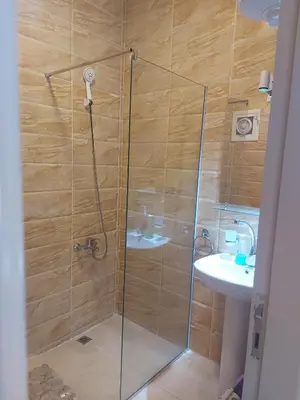a shower with a glass door next to a sink at Central location Aqua Tropical Resort Al Gouna RD 401 in Hurghada