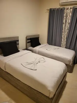 two twin beds in a room withskirts at Central location Aqua Tropical Resort Al Gouna RD 401 in Hurghada