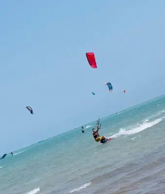 a man kite surfing in the ocean on the beach at Mangroovy Gouna 1 BR apartment in Hurghada