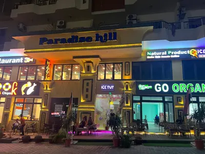 a shopping mall at night with people in front of it at Paradise Hill Compound in Hurghada