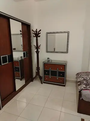 a room with a mirror and a dresser and a bed at Paradise Hill Compound in Hurghada