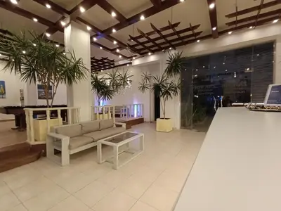 a lobby with a couch and a table and plants at Zak Inn in Hurghada