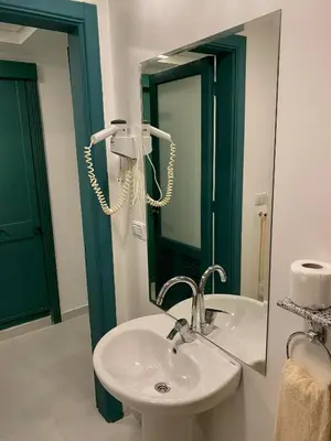 a bathroom with a sink and a mirror at Zak Inn in Hurghada