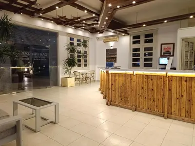 a restaurant with a bar and a table in a room at Zak Inn in Hurghada