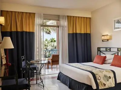 a hotel room with a bed and a balcony at Club Paradisio El Gouna Red Sea in Hurghada