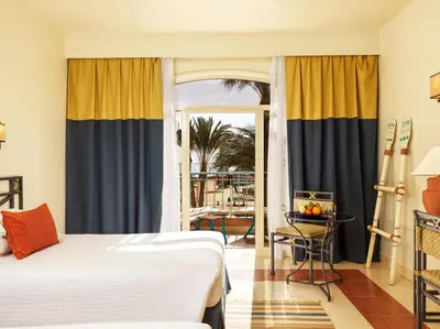 a hotel room with a bed and a balcony at Club Paradisio El Gouna Red Sea in Hurghada