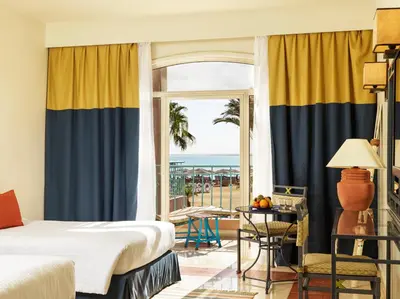 a bedroom with a bed and a view of the ocean at Club Paradisio El Gouna Red Sea in Hurghada