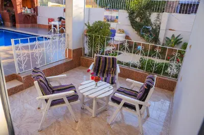 a balcony with two chairs and a table and a table and chairs at Luxor Oasis Guest House in Luxor