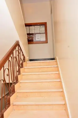 a set of stairs in a house with a sign on the wall at Fontana Hostel luxor in Luxor