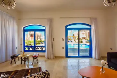 a living room with blue doors and a pool at Luxury 8BR Villa with seaview and private pool in Hurghada in Hurghada