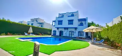 a house with a swimming pool in front of it at Luxury 8BR Villa with seaview and private pool in Hurghada in Hurghada