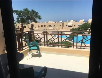 a room with a balcony with a view of a pool at Pool view one bedroom - B203 in Hurghada
