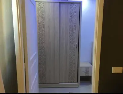 a wooden door in a room with a hallway at Pool view one bedroom - B203 in Hurghada