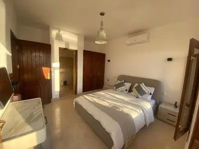 a bedroom with a bed and a tv in it at Sabina 2br penthouse in Hurghada