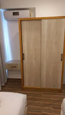 a wooden door in a room with a bed at La Casa Beach in Hurghada