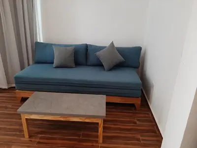 a blue couch in a room with a coffee table at La Casa Beach in Hurghada