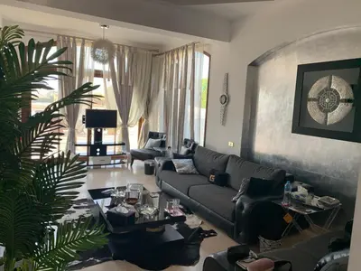 a living room with a couch and a table at 3Bedrooms Villa with Private Pool and direct Lagoon Access in Hurghada