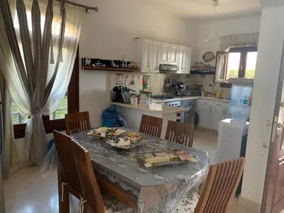 a kitchen with a table and chairs and a kitchen with a table and chairsktop at 3Bedrooms Villa with Private Pool and direct Lagoon Access in Hurghada
