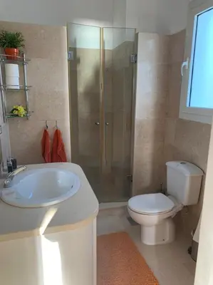 a bathroom with a toilet and a sink and a shower at Snow White Villa in Hurghada