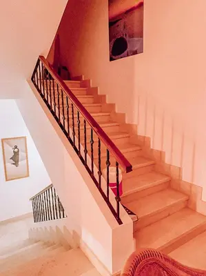 a staircase in a home with a wooden stair case at Snow White Villa in Hurghada